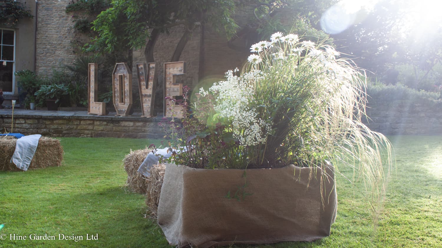 garden styling for wedding with grasses and daisys
