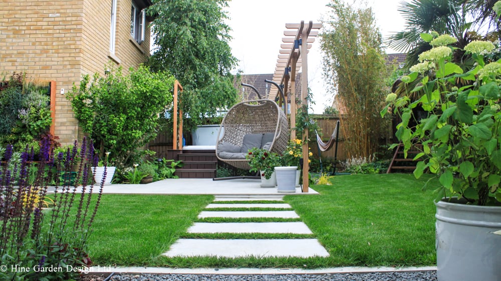 designed steps in garden wall with planting and corner pergola
