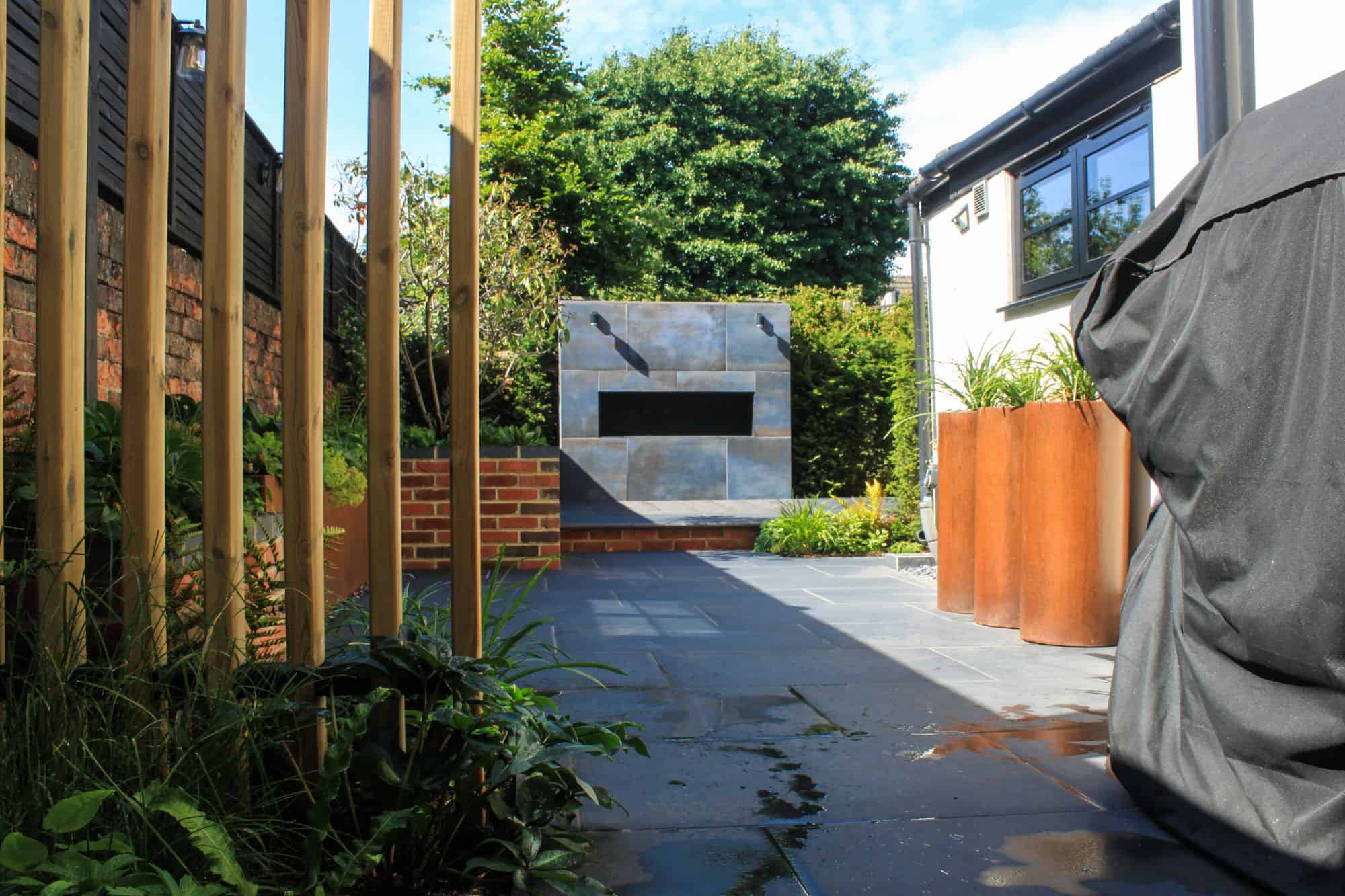 designed steps in garden wall with planting and corner pergola