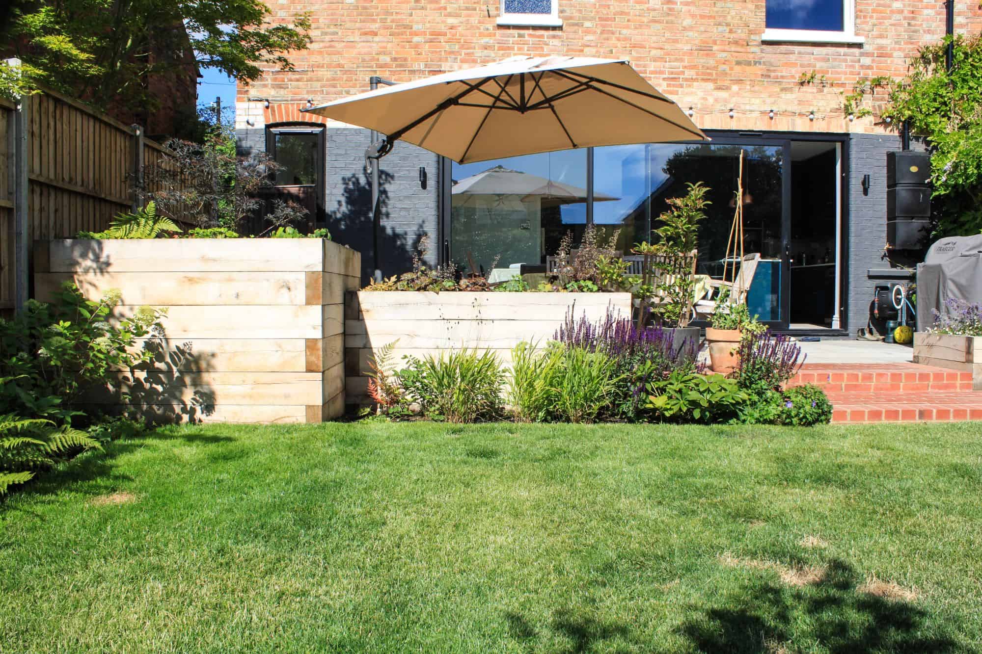 designed steps in garden wall with planting and corner pergola