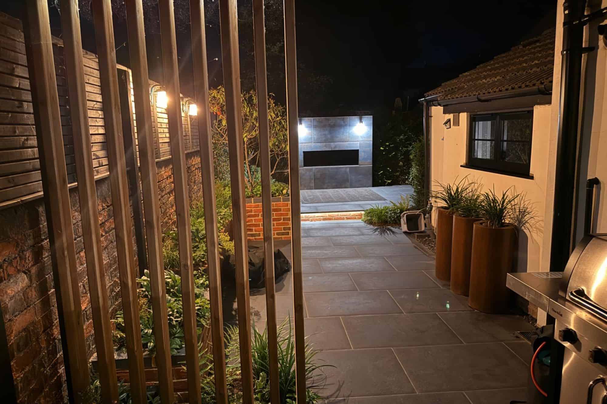 designed steps in garden wall with planting and corner pergola